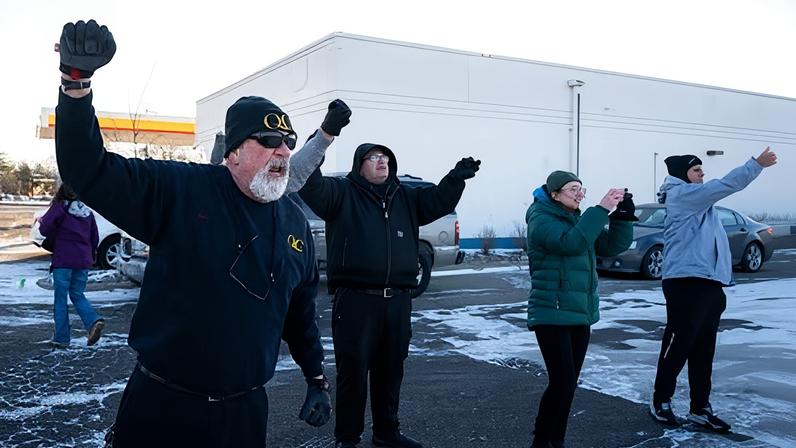 A group of residents of Bloomington, a suburb of Minneapolis, shout at a group of immigration officers who had arrested a group of men traveling in a vehicle at an intersection in Minneapolis, Minnesota on 30 January 2026.