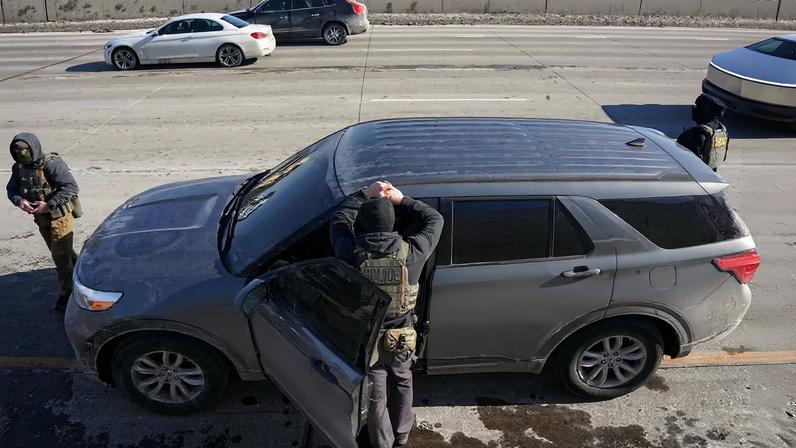 Federal immigration agents stand at Interstate 35W, while conducting immigration enforcement tasks in Minneapolis, Minnesota, U.S., February 3, 2026. REUTERS/Seth Herald
