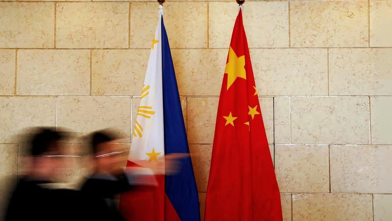 National flags are placed outside a room where Philippine Finance Secretary Carlos Dominguez and China's Commerce Minister Gao Hucheng address reporters after their meeting in Beijing