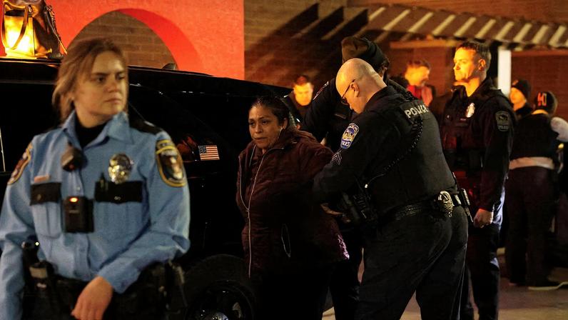 Local police detain a protester against U.S. Immigration and Customs Enforcement (ICE) outside a Target store in Richfield, Minnesota, U.S. February 11, 2026. REUTERS/Go Nakamura
