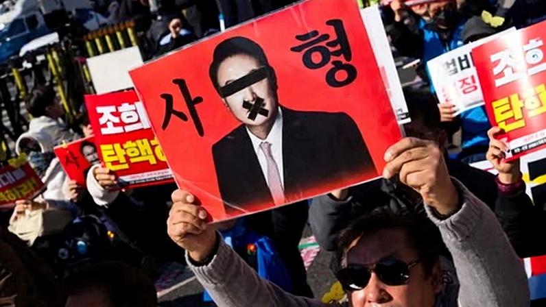 An anti-Yoon protester holds a sign calling for the death sentence for the former South Korean president.
