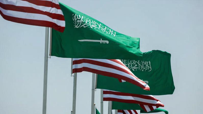 U.S. and Saudi flags flutter along a highway of Riyadh, as pictured through the glass of a car, ahead of the arrival of U.S. President Donald Trump to Riyadh, Saudi Arabia May 12, 2025.