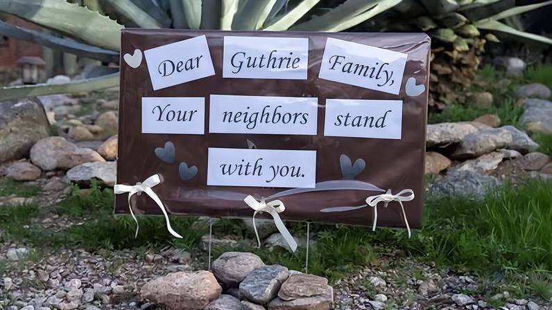 A supportive sign left by neighbors posted outside of the home of Nancy Guthrie.