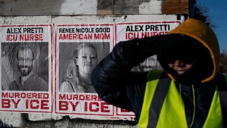A resident keeps watch for federal agents on a Minneapolis street on 29 January 2026.
