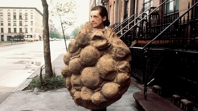 “A rumpled mother goddess accidentally teleported to Chelsea”: Bourgeois outside her New York apartment wearing her latex sculpture Avenza (1968-69)