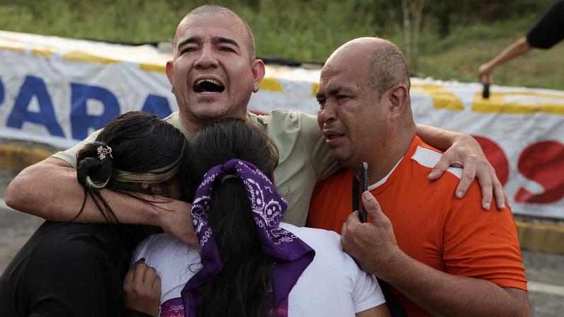 Pastor Richard Puentes hugs his family after his release from the Rodeo detention center, after Venezuelan lawmakers approved a limited amnesty bill for certain prisoners, in Guatire, Venezuela February 23, 2026. REUTERS/Gaby Oraa