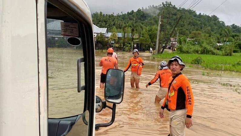Rescuers wading along a flooded street as they try to locate trapped residents when another storm earlier this month, Tropical Storm Penha, hit Surigao city on Friday, Feb. 6, 2026. (Philippine Coast Guard via AP)