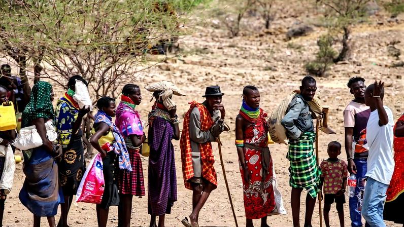 Locals queue to receive relief food as severe drought continues, in Lomekulu Village, Turkana County, Kenya, Sunday, Feb. 8, 2026. (AP Photo/Patrick Ngugi)