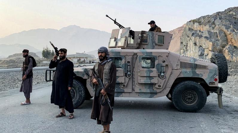 Taliban security personnel stand guard near the Torkham border crossing between Afghanistan and Pakistan.