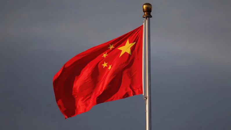China’s national flag flutters in the wind lit by sunrise in Beijing, China, November 20, 2025. REUTERS/Maxim Shemetov