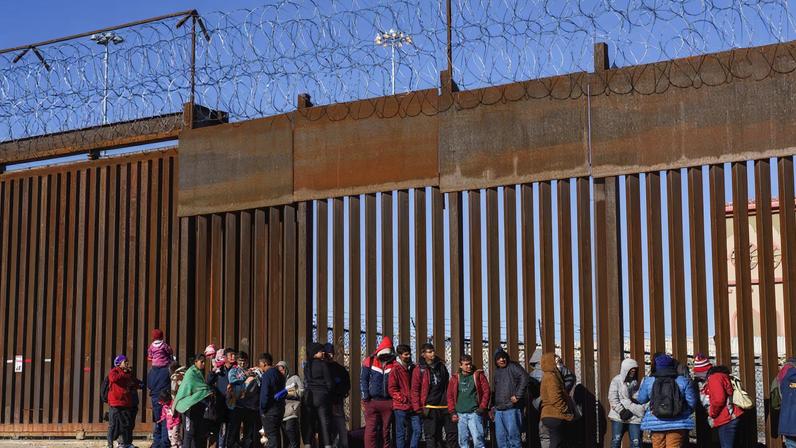Migrants from Nicaragua, Ecuador and other nationalities are pictured at a door on the border wall waiting to be picked up by the United States Border Patrol in El Paso, Texas, U.S., January 4, 2023. REUTERS/Paul Ratje