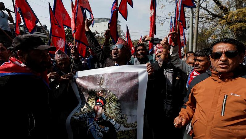 Pro-monarchy supporters holding a portrait of former King of Nepal Gyanendra Bir Bikram Shah Dev, chant slogans as they wait to welcome him in Kathmandu, Nepal, February 13, 2026.