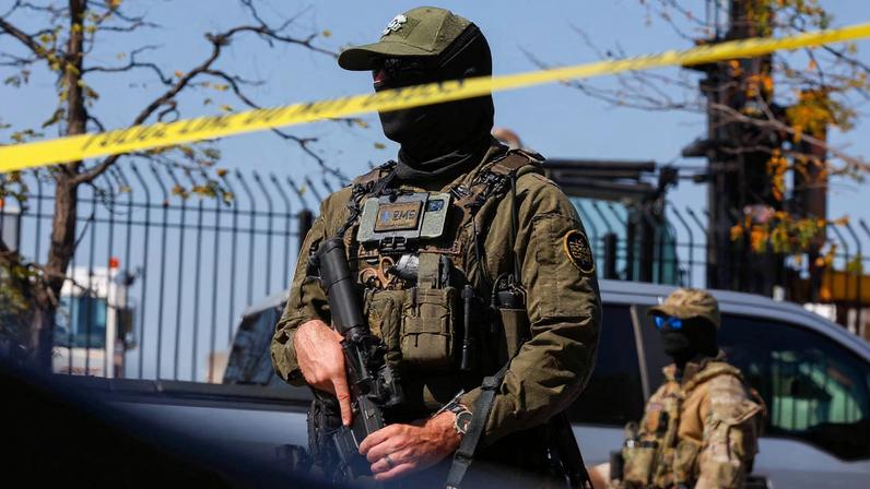 A U.S. Border Patrol officer stands behind tape during demonstrators' standoff with U.S. Immigration and Customs Enforcement (ICE) and federal officers in the Little Village neighborhood of Chicago, Illinois, U.S., October 4, 2025.