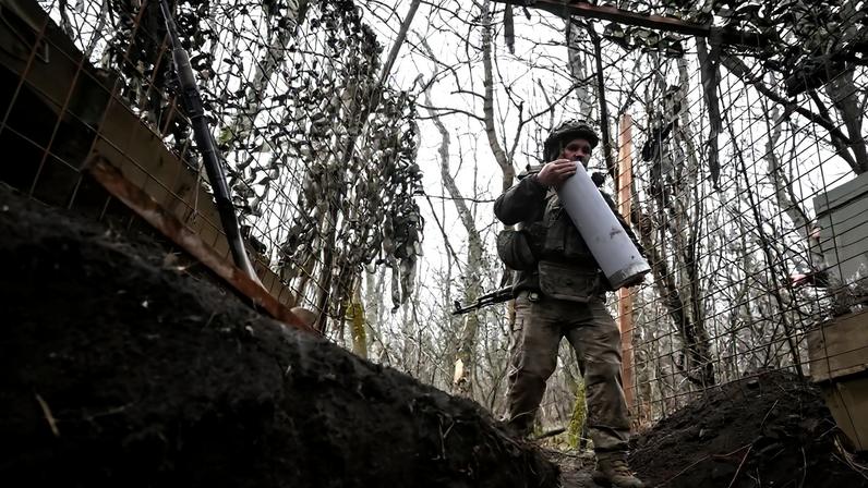 Ukrainian servicemen fire a howitzer towards Russian troops near the frontline town of Pokrovsk