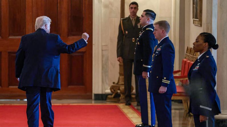 U.S. President Donald Trump raises his fist as he leaves at the end of an event to honor "Angel Families" who have lost family members to crimes committed by people in the country illegally, at the White House in Washington, D.C., U.S., February 23, 2026.