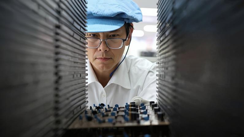 A worker producing integrated circuit products in a workshop in Weihai, Shandong Province, China, on Sept. 9, 2025. Costfoto/NurPhoto via Getty Images