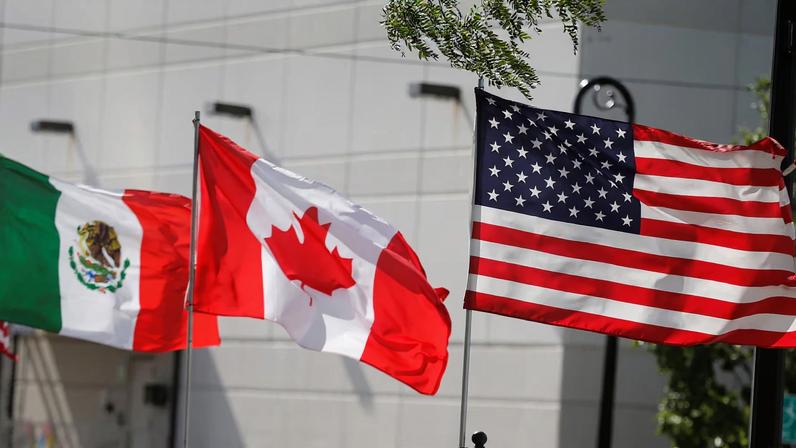 Flags of the U.S., Canada and Mexico fly next to each other in Detroit, Michigan
