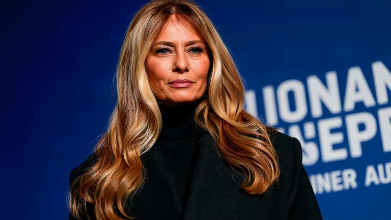 U.S. first lady Melania Trump stands next to her 2025 inaugural gown in the Flag Hall of the Smithsonian's National Museum of American History in Washington, D.C., U.S., February 20, 2026.