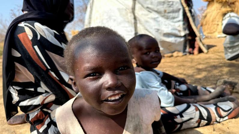 A boy reacts as he sits with his family, displaced from Kadugli, at Embal Camp in Engpung County