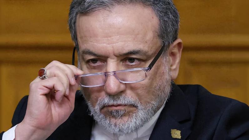 Iranian Foreign Minister Abbas Araqchi adjusts glasses during a press conference following talks with Russian Foreign Minister Sergei Lavrov in Moscow, Russia, December 17, 2025.