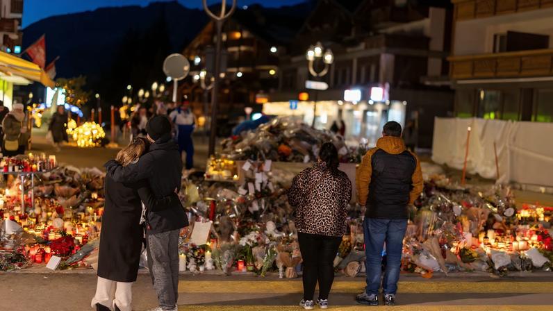 People visit a makeshift memorial outside the "Le Constellation" bar, after a deadly fire and explosion during a New Year's Eve party, in the upscale ski resort of Crans-Montana in southwestern Switzerland, January 5, 2026.