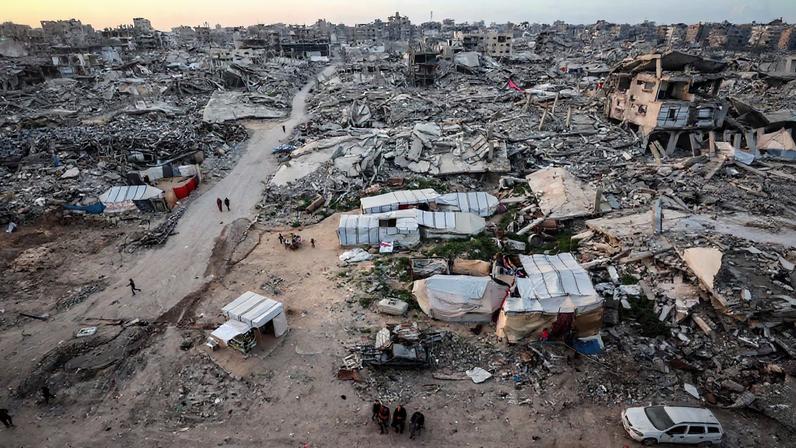 Palestinians gather near the rubble of residential buildings destroyed during the two-year Israeli offensive, on the first day of the holy month of Ramadan, in Gaza City, February 18, 2026.
