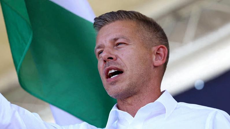 Peter Magyar, leader of the opposition Tisza party, waves a Hungarian flag at a rally near the venue of ruling Fidesz party closed doors meeting where Prime Minister Viktor Orban discusses campaign issues with party officials in Kotcse, Hungary September 7, 2025.