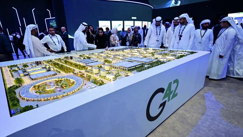 Guests look at a model of what is intended to be the largest data center in the UAE, under construction in Abu Dhabi as the Stargate initiative, during the International Petroleum Exhibition and Conference in Abu Dhabi, United Arab Emirates, on Nov. 3, 2025.