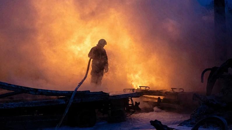 A Ukrainian emergency responder works to extinguish a fire at the site of an air attack in Kyiv on Jan. 24.