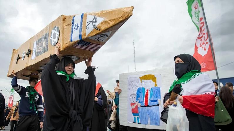 An Iranian woman carries a rocket replica to mark the anniversary of the 1979 Iranian Revolution, seen in Tehran on Feb. 11.