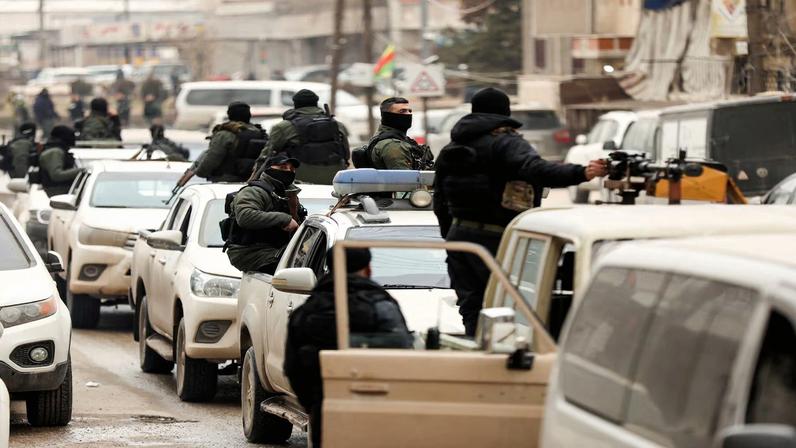 Members of the Kurdish Internal Security Forces wait for the arrival of the security forces of the Syrian government during the curfew, following an agreement between the Syrian Democratic Forces and the Syrian government, in Qamishli, Syria, February 3, 2026.