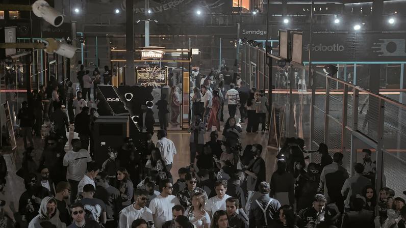 Participants dance to music amid a shower of neon light during a neon padel party, organised by 12xperience, at Padelverse in Karachi, Pakistan, November 29, 2025. REUTERS/Akhtar Soomro