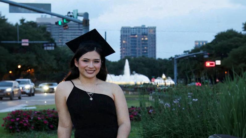 Babson College student Any Lucia Lopez Belloza poses wearing a mortarboard after graduating from high school in Boston