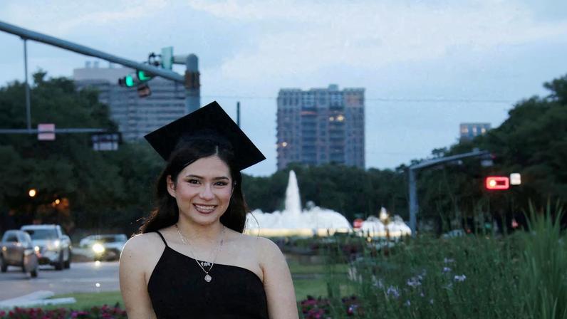 Babson College student Any Lucia Lopez Belloza poses wearing a mortarboard after graduating from high school in Boston