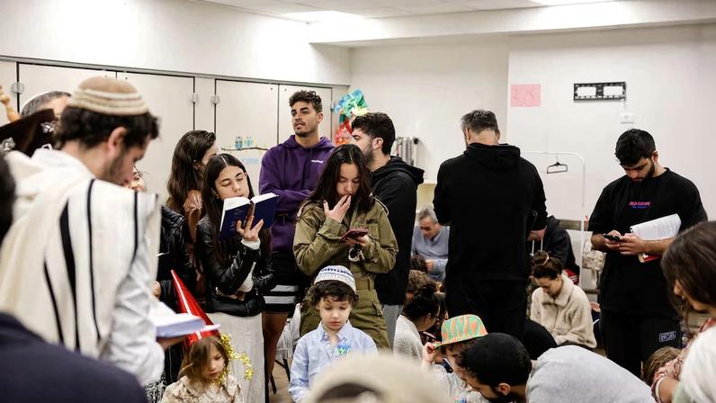 Israelis gather in a bomb shelter after missiles were launched towards Israel from Iran, in Tel Aviv