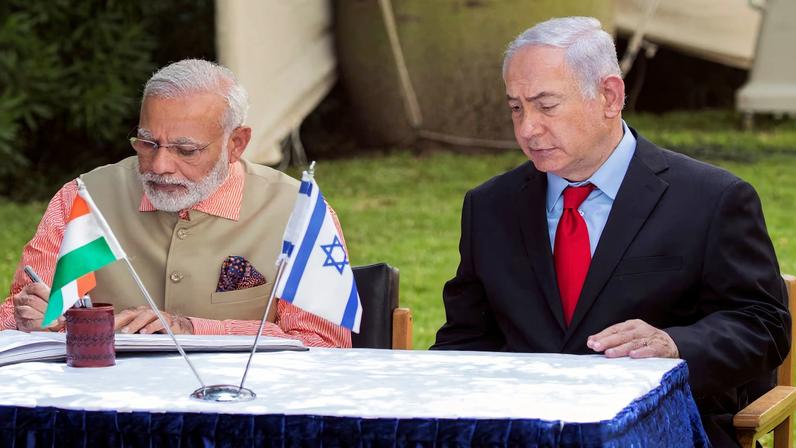 Indian Prime Minister Narendra Modi (L) and Israeli Prime Minister Benjamin Netanyahu sign the guest book at the Indian Army Cemetery of World War I to honour fallen Indian soldiers, in the Israeli coastal city of Haifa