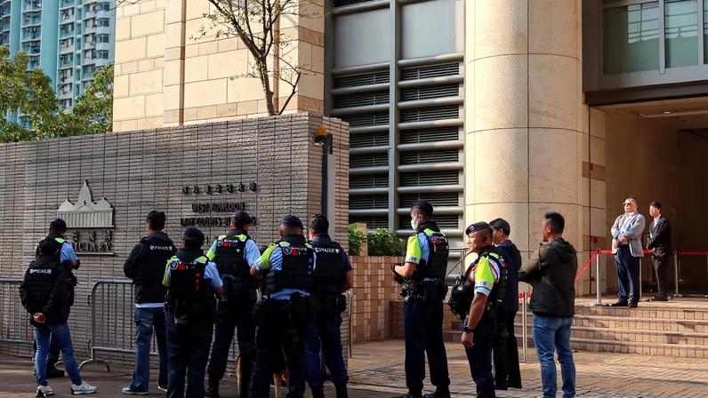 Police stand guard outside the West Kowloon Magistrates' Courts as twelve pro-democracy activists appeal their convictions and sentences in a landmark national security case, in Hong Kong, China, February 23, 2026.