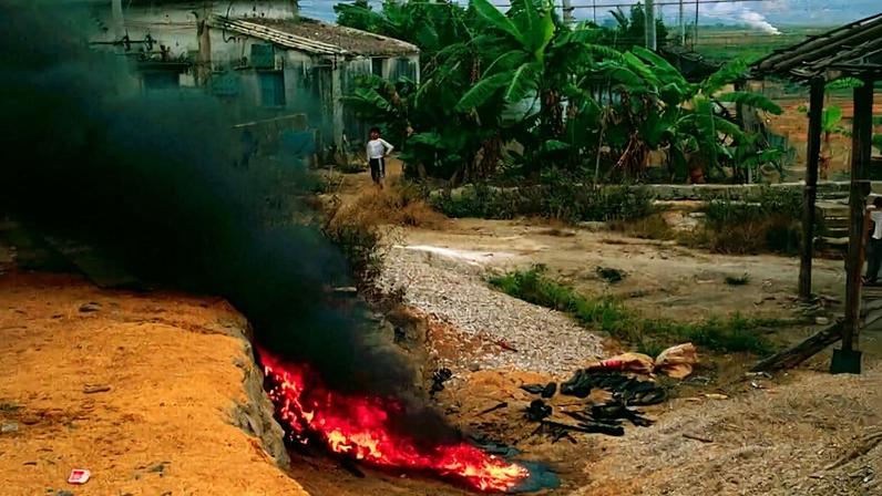 Open burning of plastic in a community in Guiyu, China. This practice is fast becoming a common way to dispose of plastic and other waste.