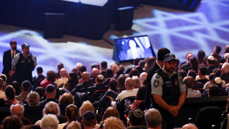 Security personnel stand guard at 'An Evening of Light & Solidarity', during Israeli President Isaac Herzog's state visit to Australia, in Sydney, Australia, February 9, 2026.