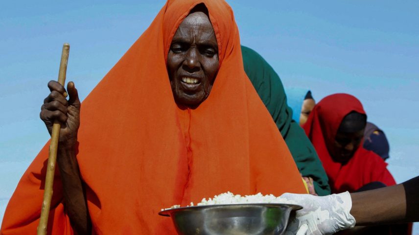 An internally displaced Somali woman receives food rations in the outskirt of Mogadishu, Somalia, March 20, 2024 REUTERS/Feisal Omar/File Photo