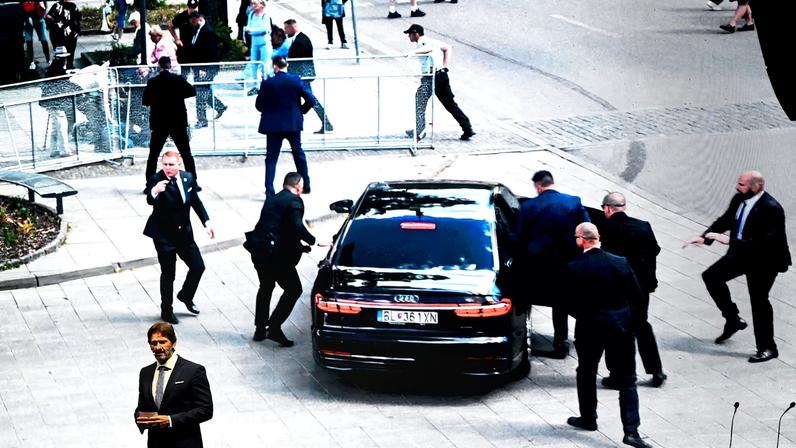 Slovak Defence Minister Robert Kalinak speaks in front of a screen displaying an image from the attempted assassination of Slovakia's Prime Minister Robert Fico, during a SMER-SSD party's rally, in Handlova, central Slovakia May 15, 2025. REUTERS/Radovan Stoklasa/File Photo