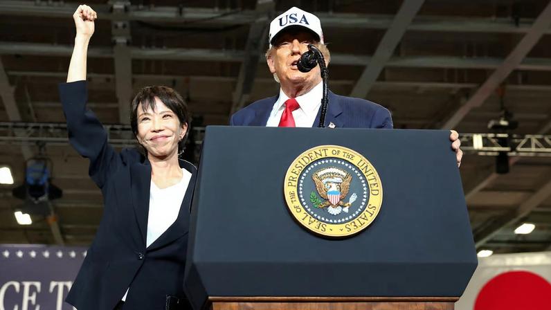 Japanese Prime Minister Sanae Takaichi gestures as U.S. President Donald Trump speaks, aboard the aircraft carrier USS George Washington, during a visit to U.S. Navy's Yokosuka base in Yokosuka, Japan, October 28, 2025.