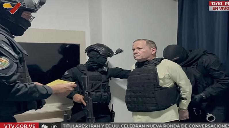 Venezuela opposition leader Juan Pablo Guanipa, wearing a bulletproof vest, looks on as he is being handcuffed, after being detained by Venezuelan law enforcement officers, at an unknown location, in this screen grab from a video released on May 23, 2025. VENEZUELAN GOVERNMENT TV/Handout via REUTERS