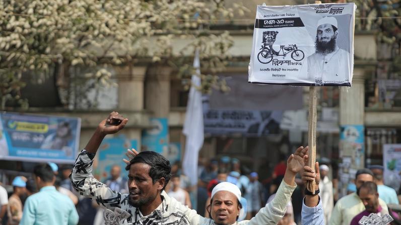 People chant slogans during an election campaign rally for candidate Mamunul Haque, head of the Bangladesh Khelafat Majlis, ahead of the national election, in Mohammadpur area, in Dhaka
