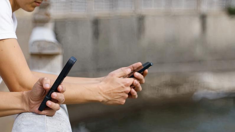 Two 15-year-olds use social media on their mobile phones in Arinaga, on the island of Gran Canaria, Spain, February 3, 2026. REUTERS/Borja Suarez/File Photo