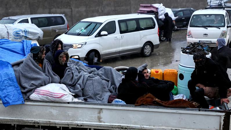 Civilians sit in a vehicle as they flee Tabqa after clashes between the Syrian Democratic Forces (SDF) and the Syrian army, in Hasakah, Syria, January 18, 2026. REUTERS/Orhan Qereman/File Photo