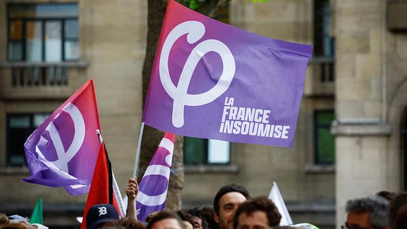 A person holds a flag of the French far-left opposition party La France Insoumise (France Unbowed - LFI) party during a political rally by the alliance of left-wing parties in Montreuil, near Paris, on the first day of official campaigning for the upcoming French parliamentary elections, France, June 17, 2024. REUTERS/Sarah Meyssonnier/ File Photo