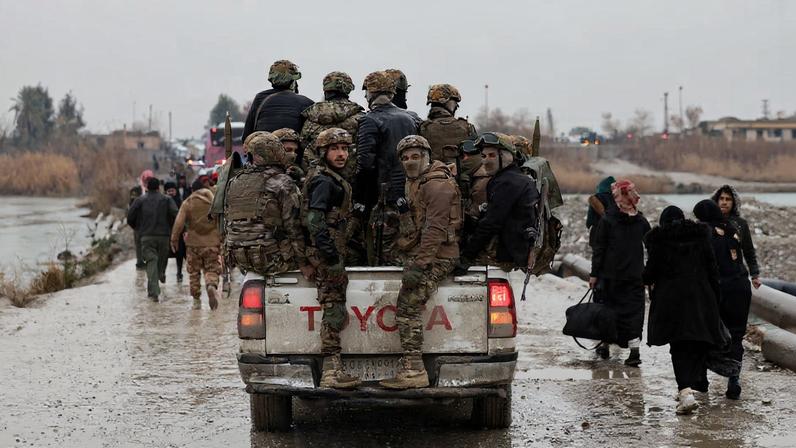 Military personnel in a vehicle at the crossing connecting the two banks of the Euphrates River, as they attempt to cross to the other side after the Syrian Democratic Forces (SDF) withdrew from Deir al-Zor province and the Syrian army took full control over the area, in Deir al-Zor, Syria, January 18, 2026. REUTERS/Khalil Ashawi/File Photo
