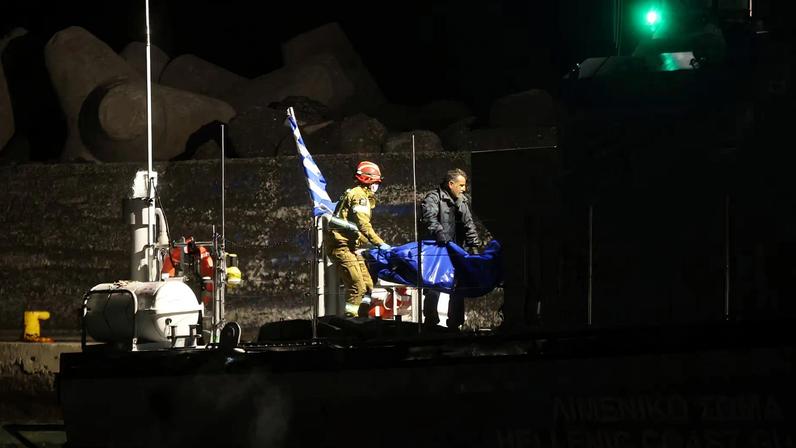 Coast guards carry bags with the bodies of drowned migrants, following a shipwreck off the tiny southern Greek island of Chrysi, in the port of Ierapetra, Crete island, Greece, December 6, 2025.