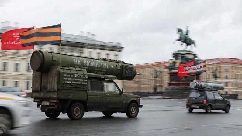 A vehicle with a model of a Russian missile on its top and attached Soviet-era flags drives along a square in Saint Petersburg, Russia March 16, 2025. REUTERS/Anton Vaganov
